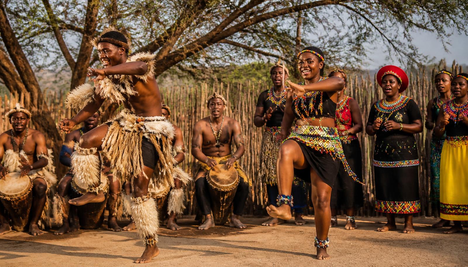 South African dancers and drummers in traditional dress performing outdoors